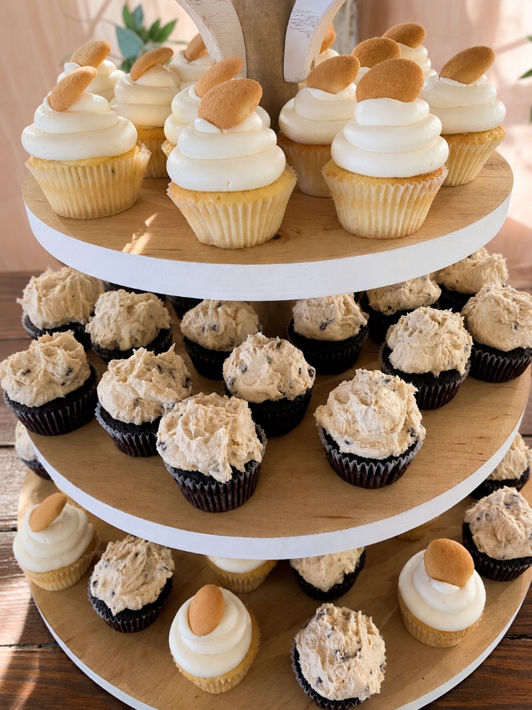 Gourmet cupcakes stacked on tiered display stand
